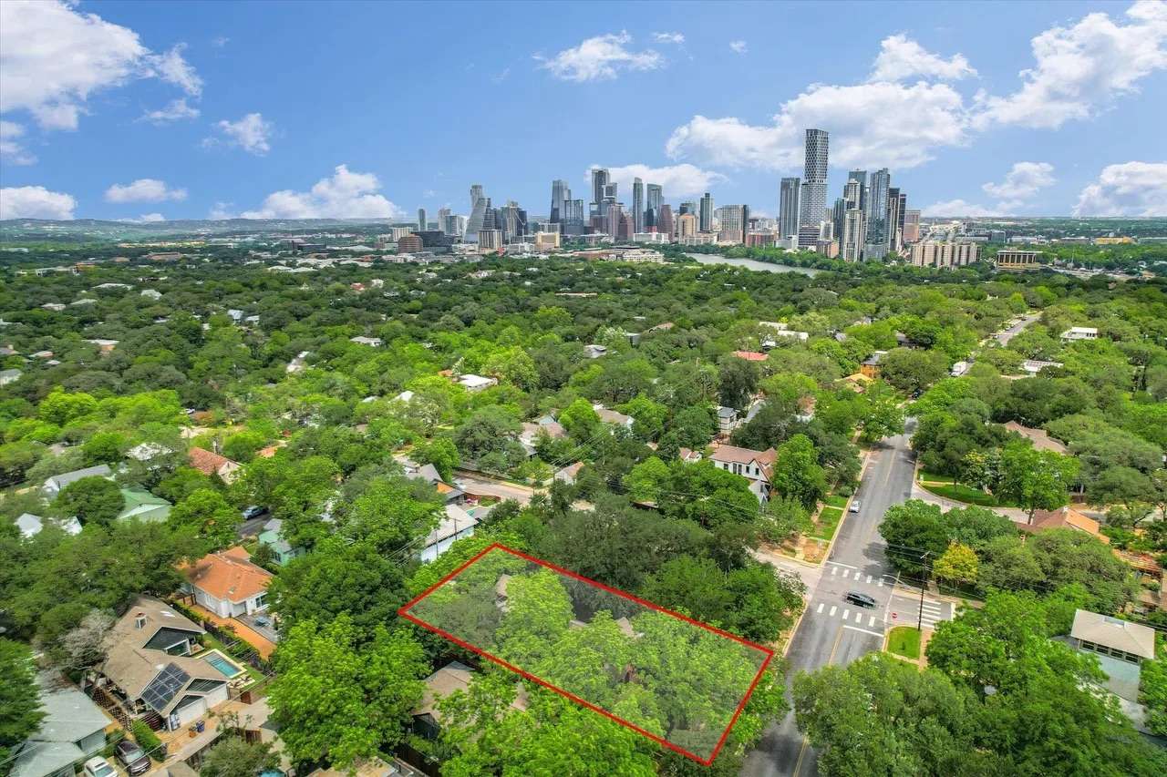 Aerial view of 1704 Travis Heights Blvd with the downtown Austin skyline behind